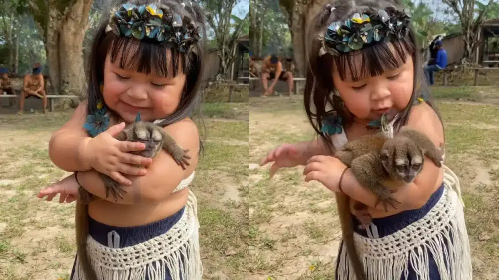 Menina indígena encanta a internet ao dançar com filhote de macaco no colo